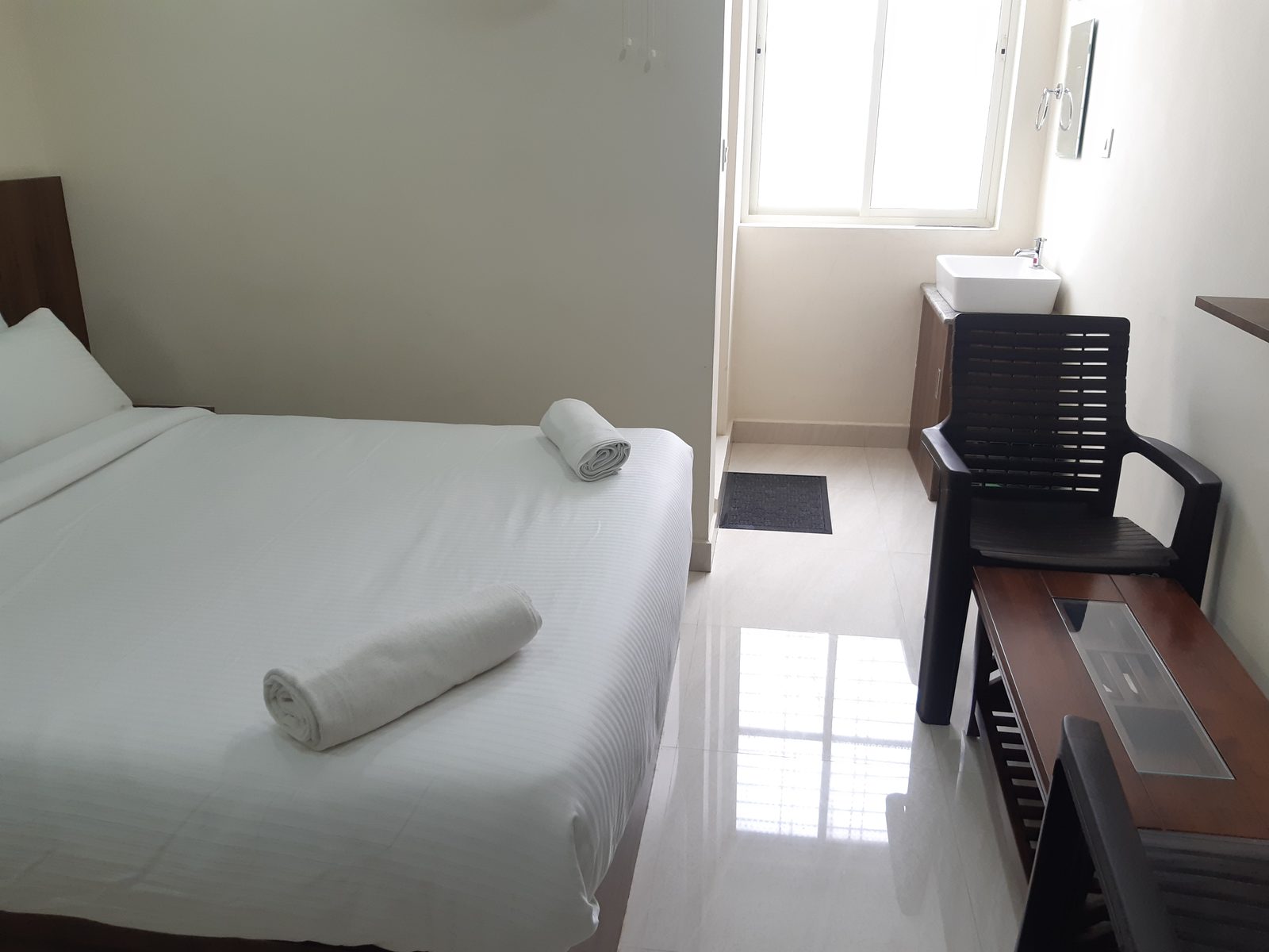 Deluxe non-A/C room with wall fan and window